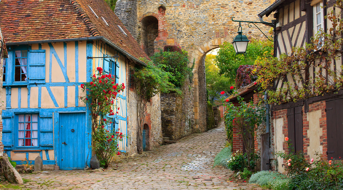 Cobbled streets, timbered house and brick archway a picturesque French village